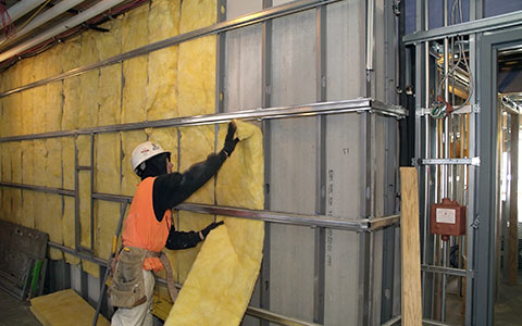 construction insulation contractor putting up insulation on a commercial project by Pronto Drywall